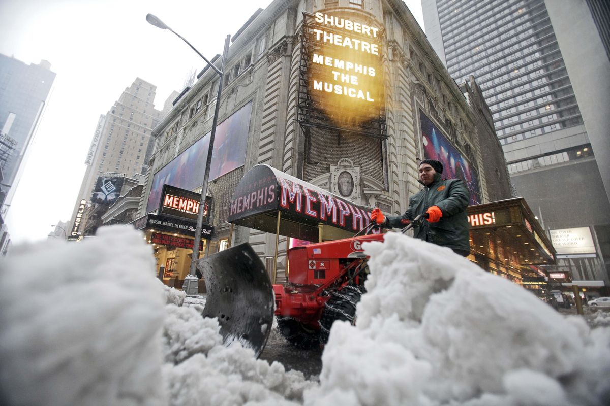 John Sarria with SL Green moves snow from Shubert Alley in New York’s Broadway theater district on Wednesday.Associated Press photos (Associated Press photos)