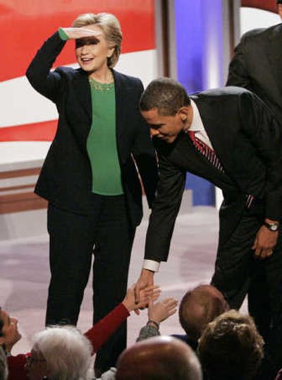 
Hillary Clinton looks into the audience as Barack Obama shakes hands after the Democratic presidential debate Saturday in Manchester, N.H. Associated Press
 (Associated Press / The Spokesman-Review)