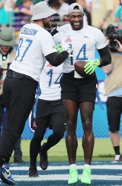 Seattle Seahawks’ DK Metcalf, right, celebrates with Dallas tight end Jake Ferguson after a touchdown during the NFL Pro Bowl on Sunday in Orlando, Fla.  (Tribune News Service)