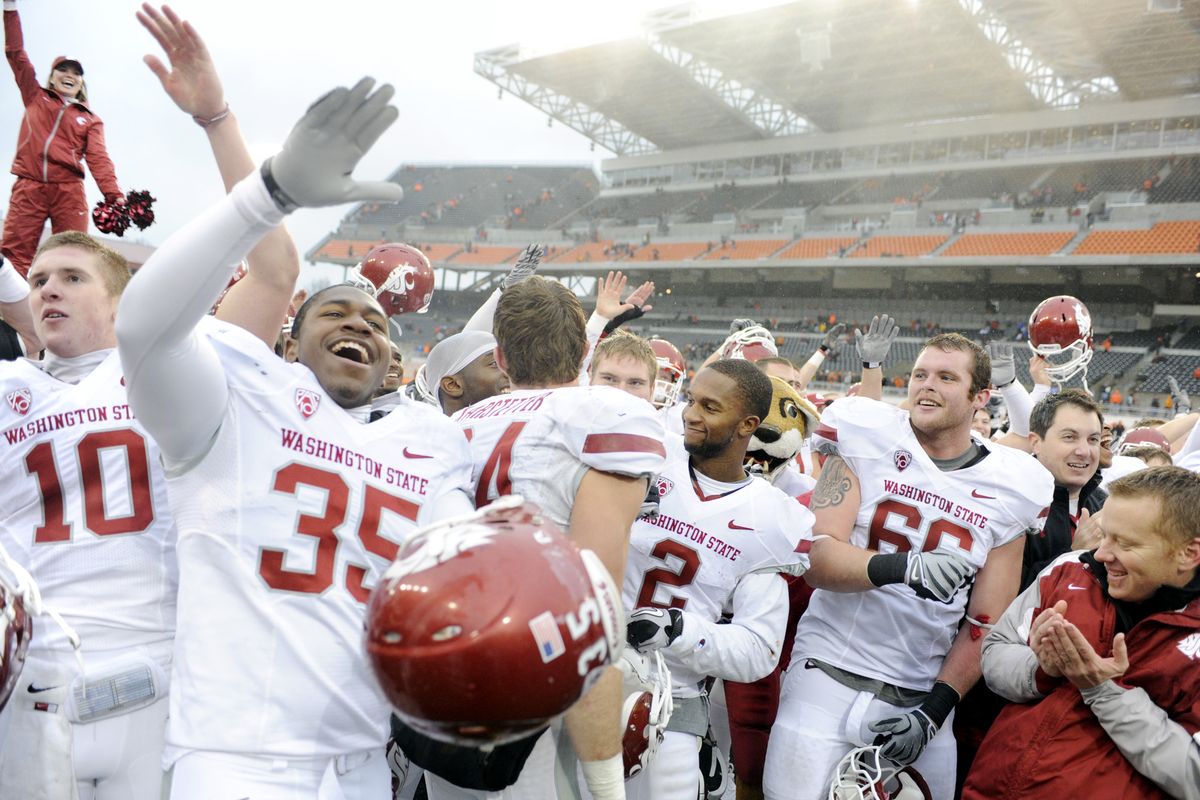 Ecstatic Cougars players gather after Saturday’s game in Corvallis, Ore., to celebrate their 31-14 upset win over Oregon State.  (Associated Press)