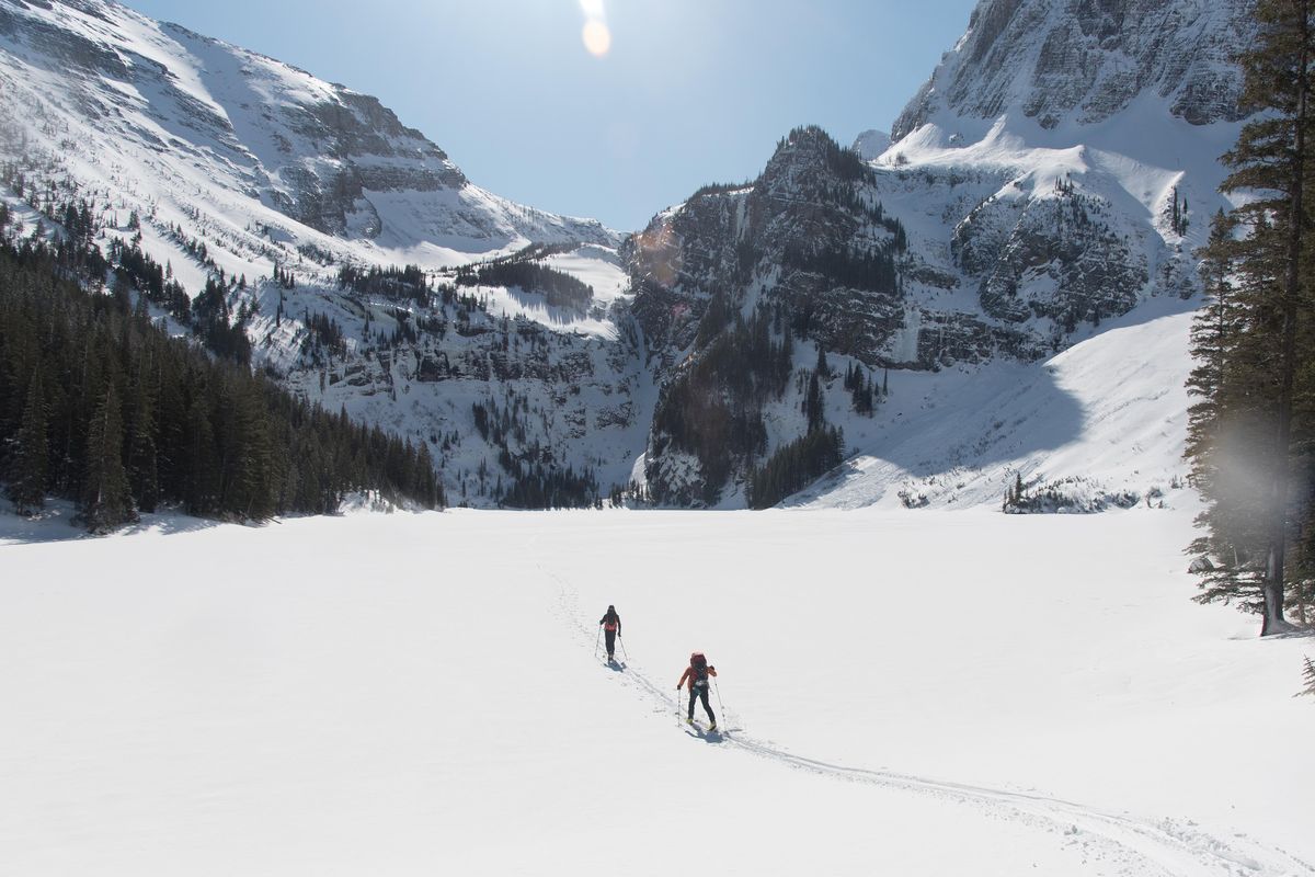 Scott Coldiron (right) and Matt Cornell ski across Granite Lake, Montana, on Saturday, March 10, 2018. For the past four climbing seasons, Coldiron has been developing a new ice climbing spot in the Montana backcountry. (Eli Francovich / The Spokesman-Review)