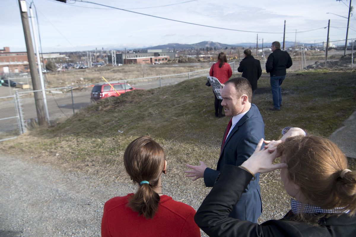 Lars Gilberts, gesturing, director of the University District, points out the large lot on the south side of the railroad tracks in the University District where Catalyst, a development arm of Avista, will build a high tech building which will bring together tech business and University classrooms. The building was announced Tuesday, Feb. 6, 2018. (Jesse Tinsley / The Spokesman-Review)