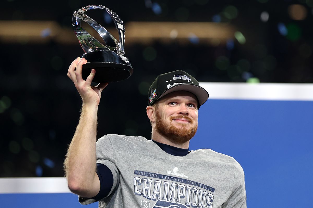 Seahawks quarterback Sam Darnold hoists the George Halas Trophy after beating the Rams in the NFC championship on Sunday at Lumen Field in Seattle.  (Getty Images)