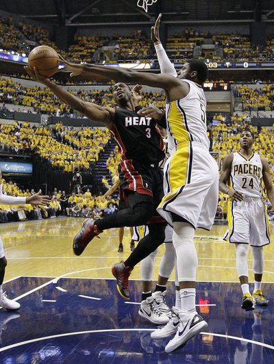 Miami Heat's Dwyane Wade, left, goes to the basket against Indiana Pacers' Roy Hibbert. Wade had a game-high 41 points. (Associated Press)