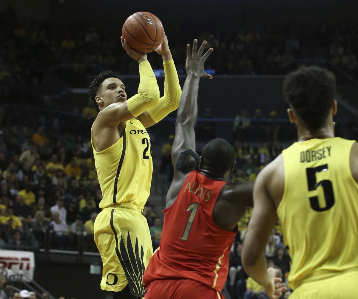 Oregon’s Dillon Brooks, left, shoots a 3-point basket over Arizona’s Rawle Alkins, center, with teammate Tyler Dorsey, right, watching during the first half of an NCAA college basketball game Saturday, Feb. 4, 2017, in Eugene. (Chris Pietsch / Associated Press)
