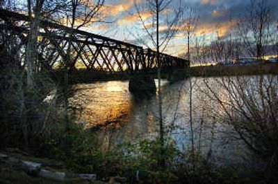 Wednesday's sunset frames the old iron bridge northeast of Trent and Hamilton at the site of a new business development.
(Christopher Anderson/ / The Spokesman-Review)