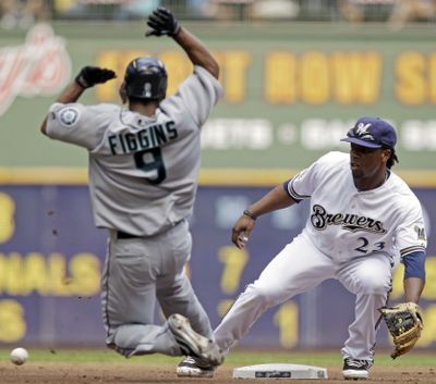Mariners' Chone Figgins swipes second base in the first inning, giving him 20 steals for seven consecutive seasons and 300 for his career. (Associated Press)