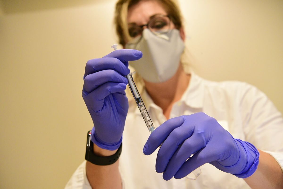 This September 2020 photo provided by Johnson & Johnson shows a pharmacist preparing to give an experimental COVID-19 vaccine. (HONS)