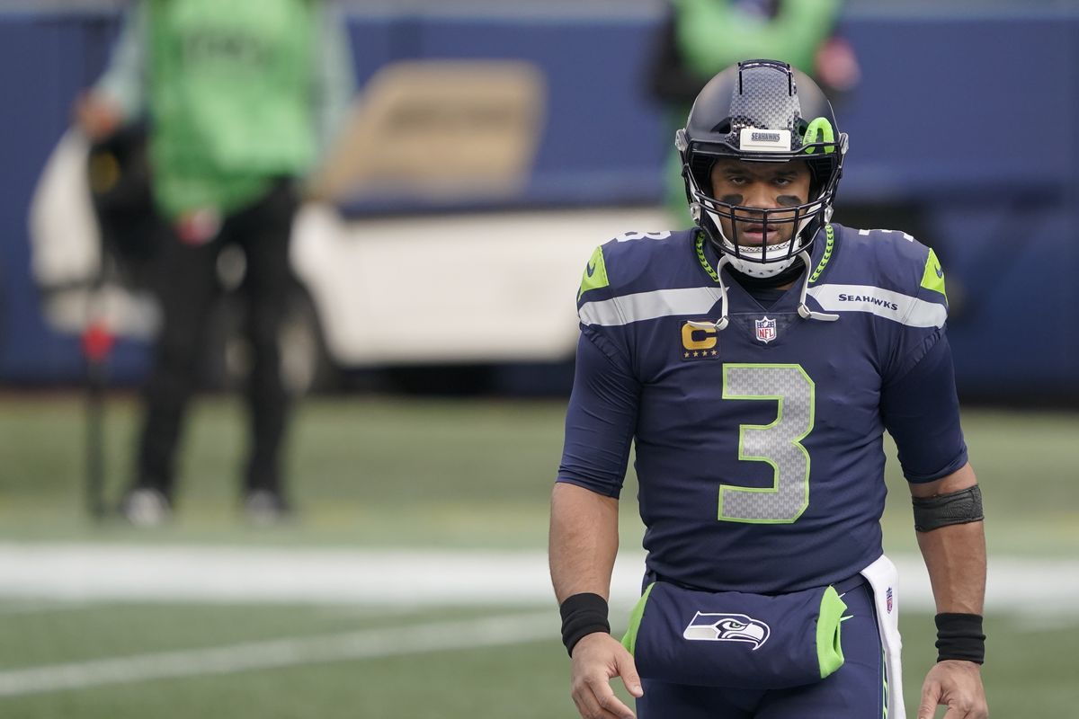 Seahawks quarterback Russell Wilson walks on the field before a playoff game Jan. 9 against the Rams.  (Ted S. Warren)
