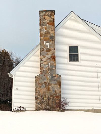 This chimney is not watertight. Look at the white efflorescence stain. Water is entering the chimney higher up and then leaking out just above the white salt deposits.  (Tribune Content Agency)