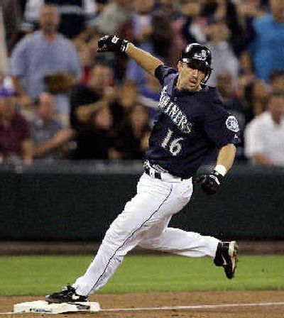 
Seattle's Willie Bloomquist looks back after reaching third on his RBI triple in the fifth Friday. 
 (Associated Press / The Spokesman-Review)