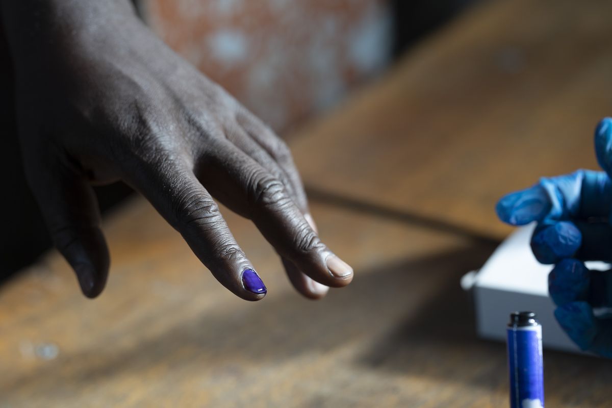 A man has his nail inked before casting his ballot for Gambia's presidential elections, in Banjul, Gambia, Saturday, Dec. 4, 2021. Lines of voters are forming outside polling stations in Gambia’s capital as the nation holds a presidential election. The election on Saturday is the first in decades without former dictator Yahya Jammeh as a candidate.  (Leo Correa)