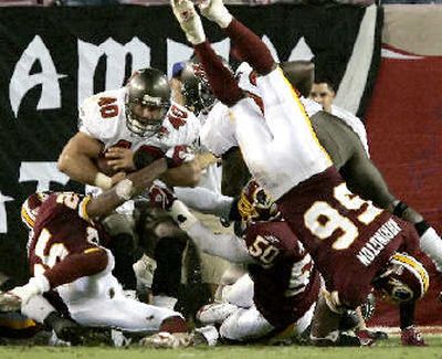 
Tampa Bay Buccaneers fullback Mike Alstott, upper left, bulls his way through the Washington Redskins defense and into the end zone for a game-winning two-point conversion on Sunday.
 (Associated Press / The Spokesman-Review)