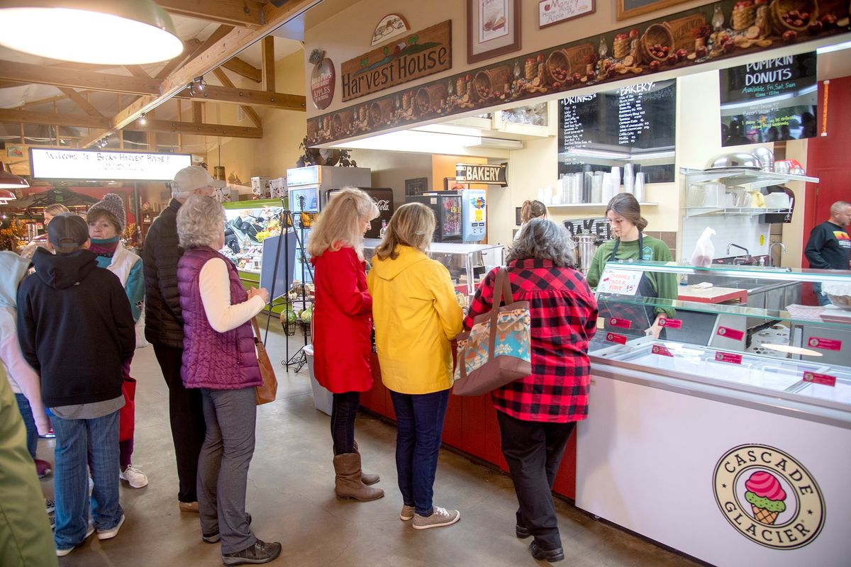 Customers line up inside and outside of Beck’s Harvest House in Green Bluff on Friday when they open to begin selling their popular pumpkin doughnuts.  (Jesse Tinsley/The Spokesman-Review)