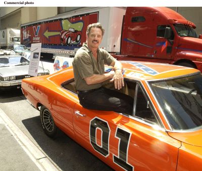 “Dukes of Hazzard” alumnus Tom Wopat poses with the General Lee, a Dodge Charger featured in the television show, in August 2002.  (PRNews)
