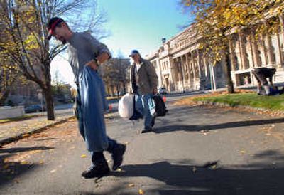 
Mike Smith, right, and Richard Bacon clear their belongings Tuesday from Riverside Avenue, where a homeless tent camp was constructed last week. 
 (Brian Plonka / The Spokesman-Review)