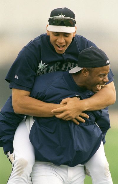 He ain’t heavy, he’s my all-star teammate. Seattle Mariner outfielder Ken Griffey Jr. gave a piggy-back ride to Alex Rodriguez during morning warmup drills at spring training in Peoria, Arizona, in 1998. (Dan Pelle / The Spokesman-Review)