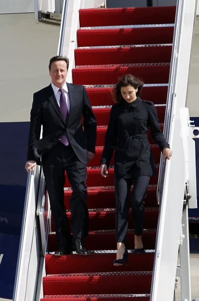 British Prime Minister David Cameron and his wife Samantha walk down the stairs from the plane upon arrival their at Andrews Air Force Base, Md., today. (AP/Jose Luis Magana)
