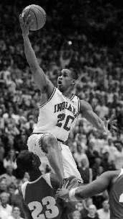 
Indiana guard AJ Ratliff puts up a shot over Wisconsin guard Kammron Taylor. 
 (Associated Press / The Spokesman-Review)