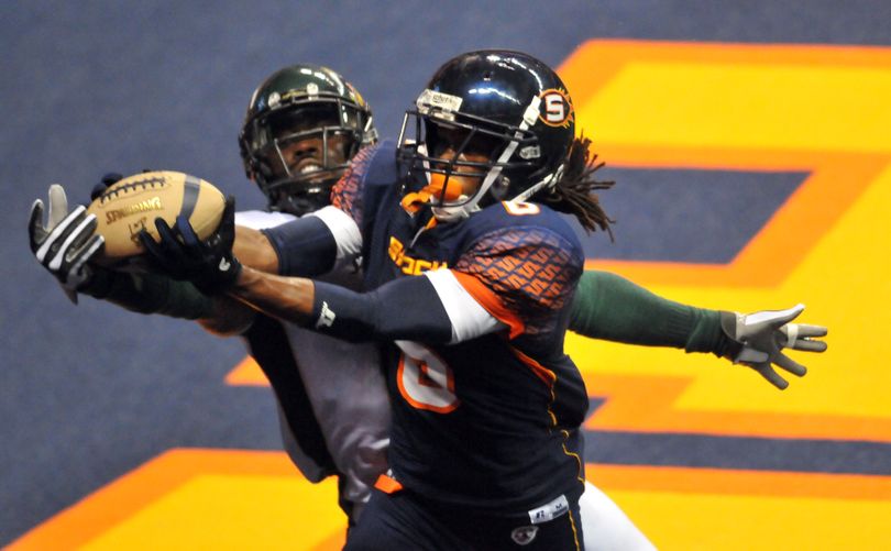Spokane Shock's Brandon Thompkins manages to haul in a long pass over the arms of the San Jose Sabercats' Quinton Andrews in the first half, Saturday, July 16, 2011, at the Spokane Arena. (Jesse Tinsley / The Spokesman-Review)