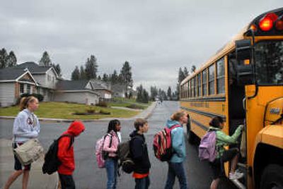 
Midway Elementary neighborhood children board a bus Thursday that will take them to Farwell Elementary, several miles away. 
 (Brian Plonka / The Spokesman-Review)