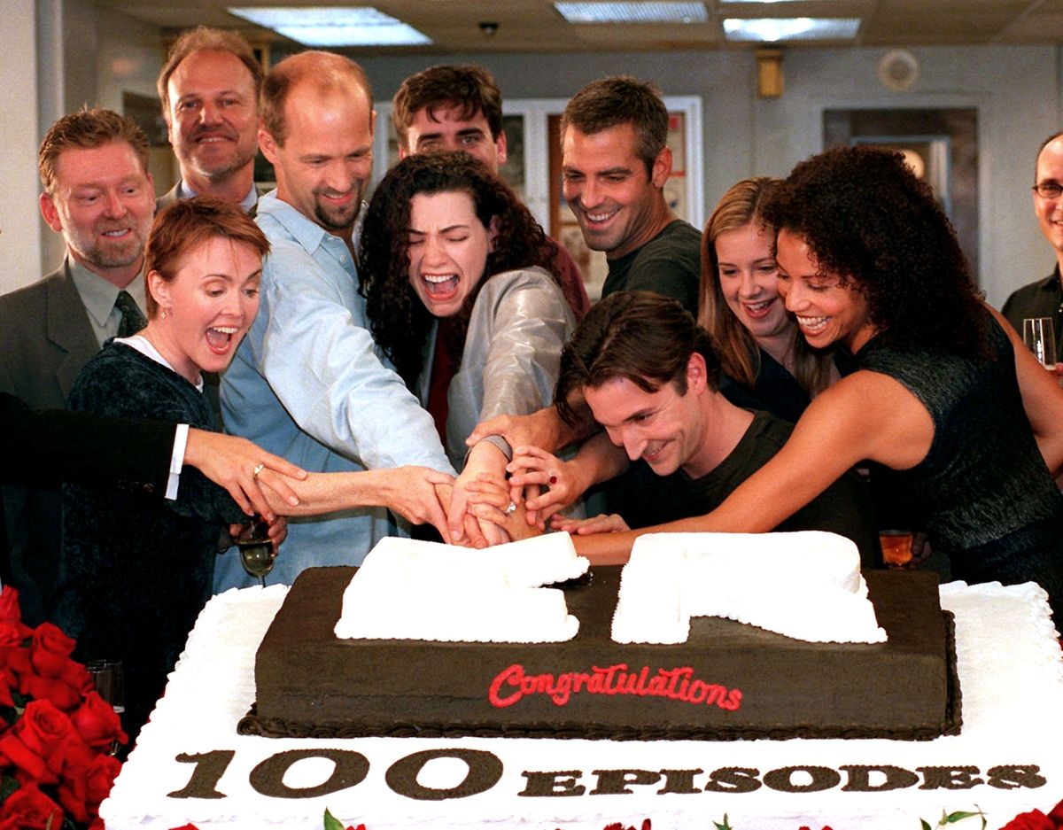 In this Oct. 20, 1998 file photo, cast members, front row from left, Laura Innes, Anthony Edwards, Julianna Margulies, George Clooney, Noah Wyle, Kellie Martin, and Gloria Reuben, cut a cake celebrating the 100th episode of the NBC series, “ER,” as NBC President Warren Littlefield, second row left, and series creator John Wells, look on. Associated Press photos (Associated Press photos / The Spokesman-Review)
