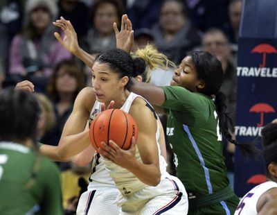 UConn’s Gabby Williams grabs a rebound against Tulane’s Harlyn Wyatt in the first half on Saturday in Storrs, Connecticut. The unbeaten, top-ranked Huskies won, 98-45. (Stephen Dunn / Associated Press)