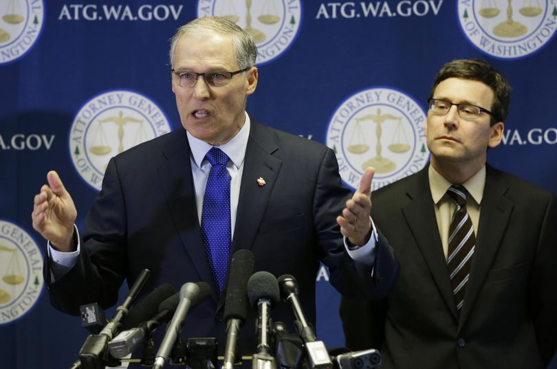 Washington Gov. Jay Inslee, left, talks to reporters as Washington Attorney General Bob Ferguson looks on Monday, Jan. 30, 2017, in Seattle. (Ted S. Warren / Associated Press)