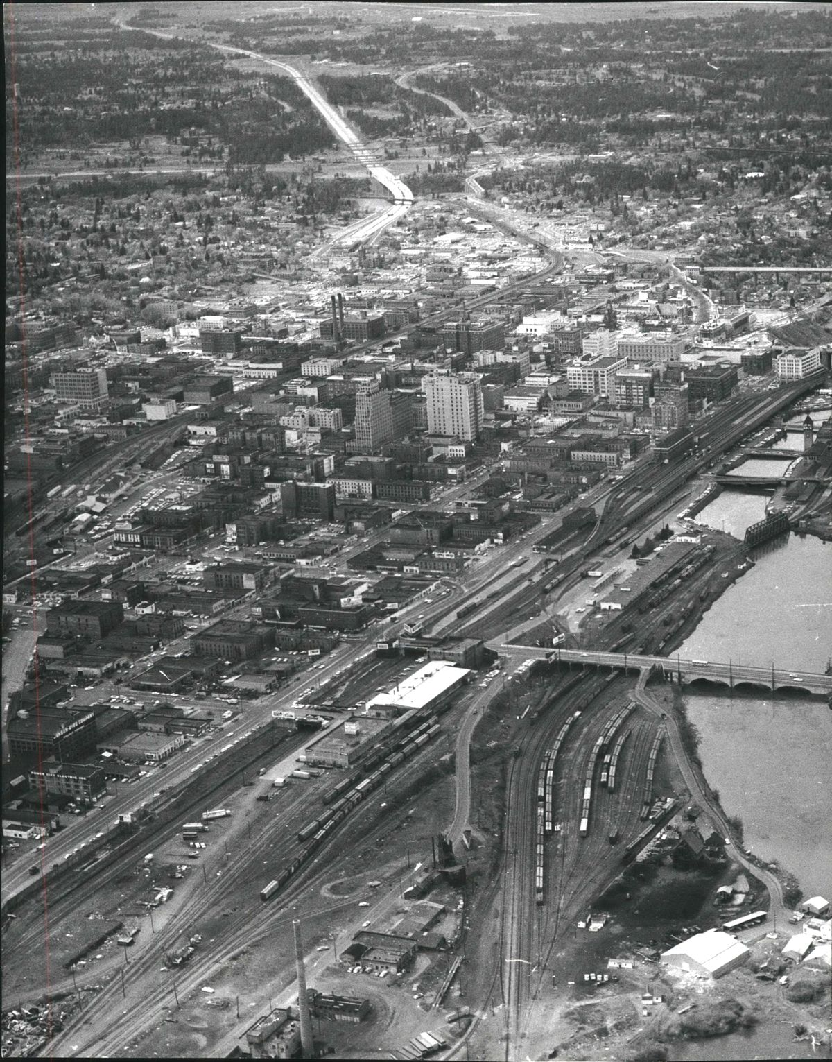 In the foreground of this 1966 photograph are the railroad tracks serving Spokane’s downtown passenger and freight depots along the Spokane River waterfront. The tracks carried frieght and passengers for the Great Northern, the Milwaukee Road, Union Pacific, the Spokane Portland and Seattle and many other lines before all were removed for Expo ’74 and the creation of Riverfront Park. (SR)