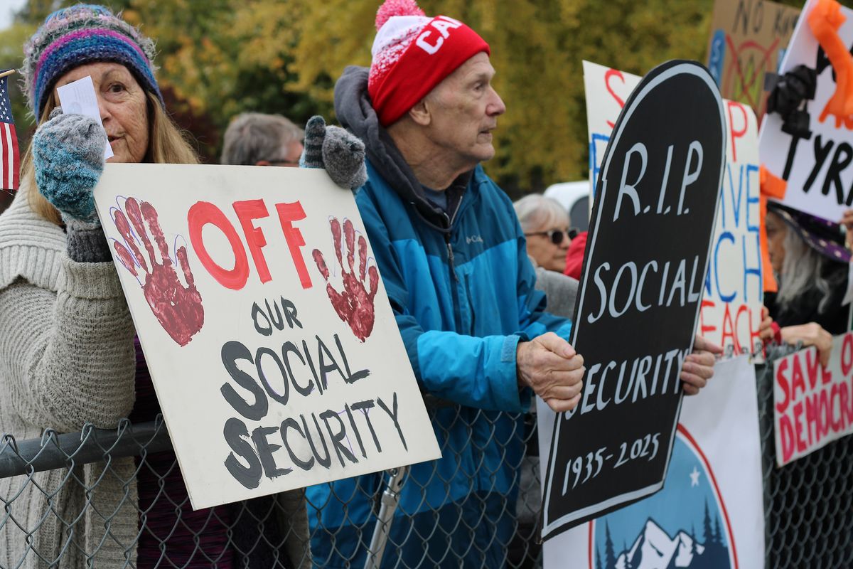 Donna and George Matter, residents of Kettle Falls, join No Kings Day on Saturday afternoon. They have a son in Chicago, who they say has witnessed the fear Latinos face daily from Immigration and Customs Enforcement Agents. (Monica Carrillo-Casas/The Spokesman-Review)
