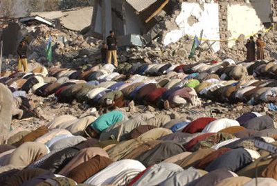 
Kashmiri eartquake survivors pray amid the debris of a destroyed building during the Eid Al-Fitr, marking the end of Ramadan in Muzaffarabad, Pakistan,  Nov. 4. 
 (Associated Press / The Spokesman-Review)