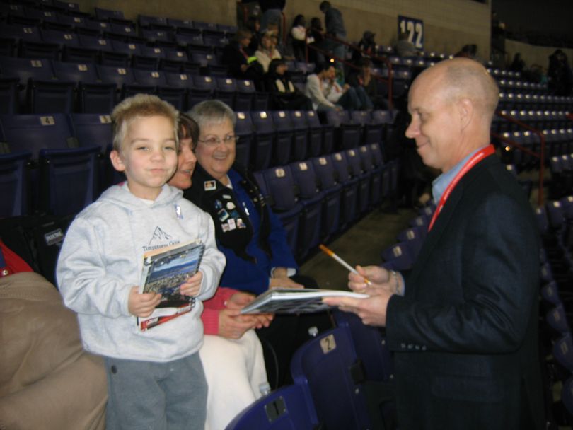 Skater star and commentator Scott Hamilton signs autographs for 7-year-old Craig Anderson while mom, Kirsten Anderson, and  grandma, Elsbeth Ellis, look on.
 (Rebecca Nappi / The Spokesman-Review)