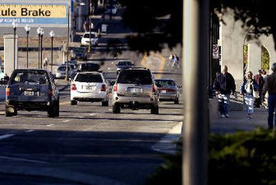 
Northbound traffic and pedestrians cross the Monroe Street Bridge on Sunday after its reopening after nearly three years of restoration work.
 (Liz Kishimoto / The Spokesman-Review)