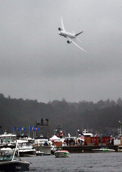 The Boeing Dreamliner 787 flies over the hydroplane race course and boats on Lake Washington as part of the Boeing Air Show earlier this month in Seattle.  (Associated Press)