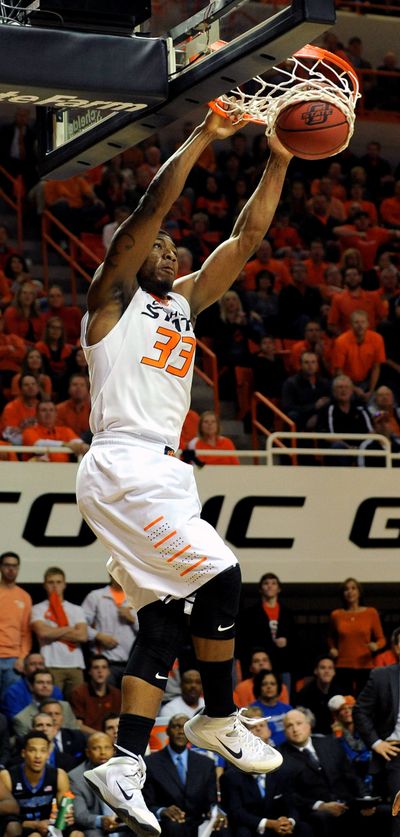 Oklahoma State guard Marcus Smart dunks for two of his 39 points in Tuesday’s win over Memphis. (Associated Press)