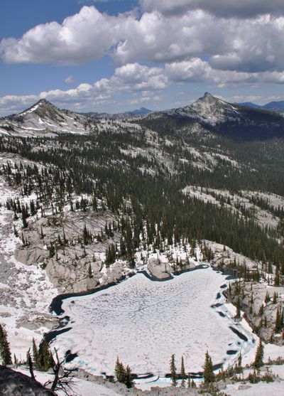  Little Harrison Lake, 6,271 feet elevation (Harrison Peak above it in the background right) was still iced over, as was nearby Beehive Lake, elev. 6,457 feet, on June 30, 2013. But the trail into Beehive was snow-free and scrambling was good on the granite slabs and ridges. (Rich Landers)