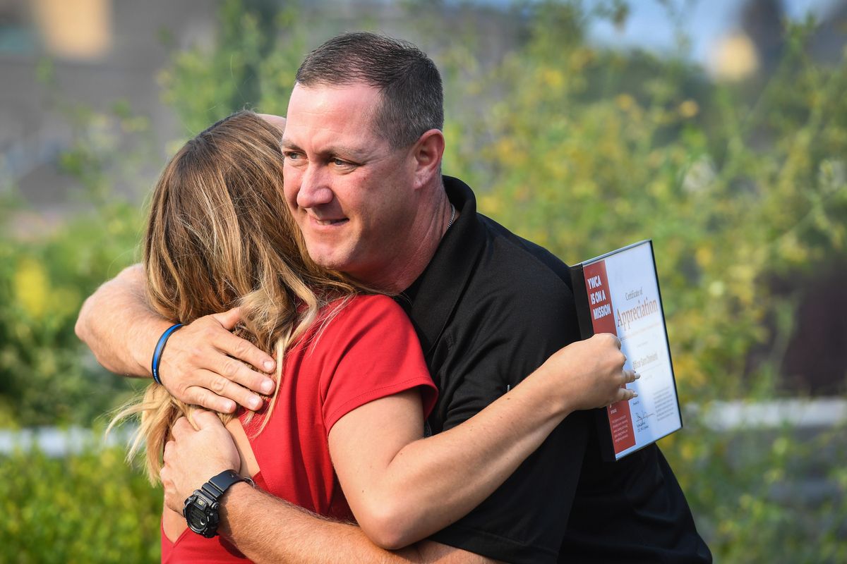 Spokane police Officer Sam Chimienti embraces Emily Morgan after he is recognized by the YWCA legal team as an honoree at the at the 5th Annual Law enforcement Appreciation Breakfast, Thursday, Aug. 23, 2018. Honorees were nominated bases on their professionalism, compassion and and positive impact on the lives of survivors of domestic violence. (Dan Pelle / The Spokesman-Review)