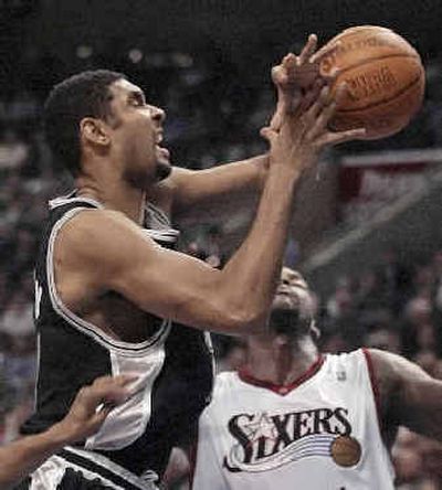 
Spurs' Tim Duncan, fouled by 76ers' Willie Green, scored 34 points.
 (Associated Press / The Spokesman-Review)
