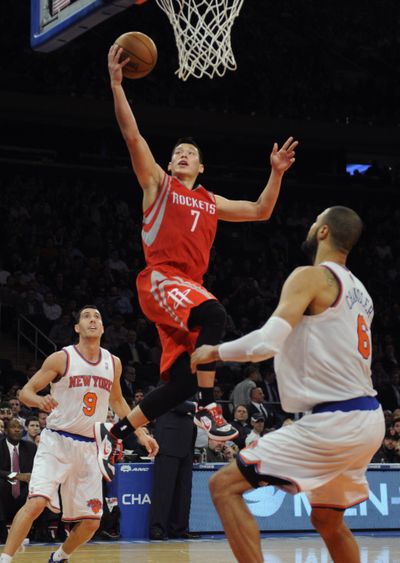Jeremy Lin of the Houston Rockets scores two of his 22 points in his first game at Madison Square Garden since “Linsanity.” (Associated Press)
