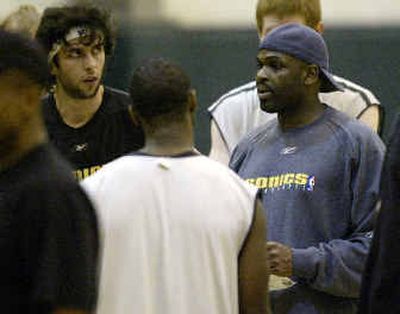 
Seattle's Vladimir Radmanovic, left, listens to SuperSonics coach Nate McMillan, right, during his return to practice on Thursday. 
 (Associated Press / The Spokesman-Review)