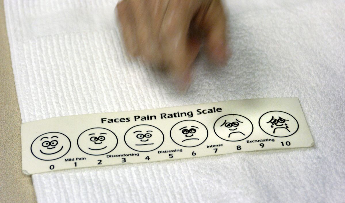 Thu Dao Nguyen is asked to rate the level of pain she is feeling during physical therapy session in north Spokane, July 17, 2006. (Dan Pelle / The Spokesman-Review)