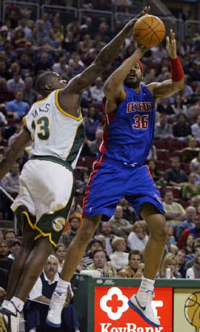 
Detroit Pistons forward Rasheed Wallace, right, gets his shot redirected by Seattle's Jerome James on Friday night in Seattle.
 (Associated Press / The Spokesman-Review)