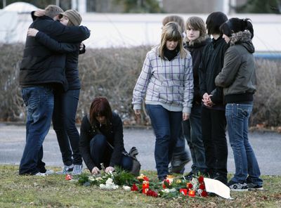 Students place flowers in front of the Albertville school in Winnenden, Germany, on Wednesday.  (Associated Press / The Spokesman-Review)