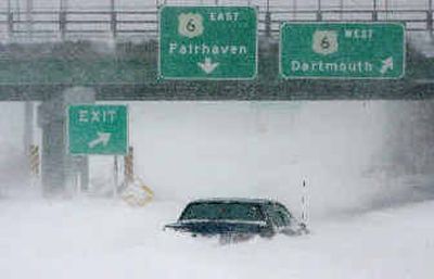 
An abandoned car sits amid drifting snow on southbound Route 18, just short of the Route 6 exit, on Sunday in New Bedford, Mass., after a storm hit the region.
 (Associated Press / The Spokesman-Review)