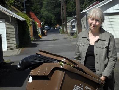 Corbin Park resident Gina McKenzie and a group of others have persuaded  City Hall  to continue alley garbage pickup service for about 2,000 residences.  (FILE / The Spokesman-Review)