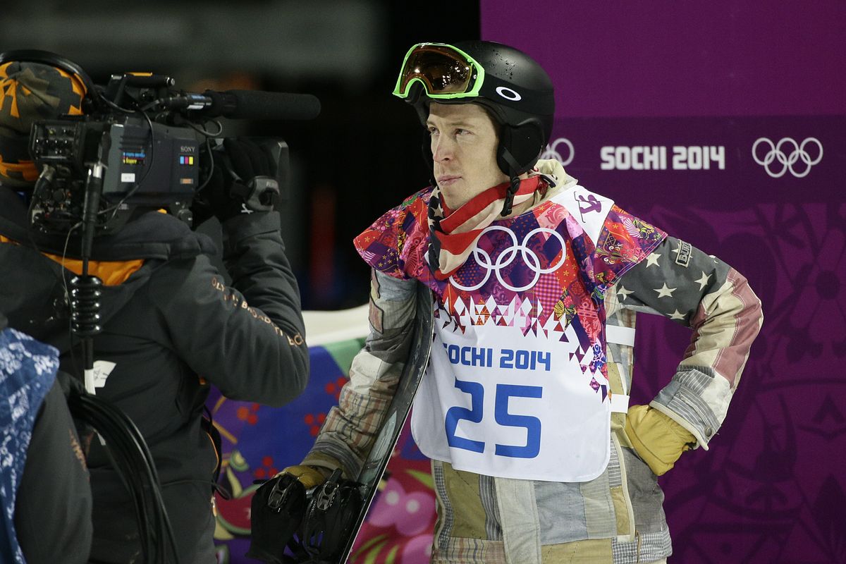 A dejected Shaun White, of the United States, looks at the scoreboard after competing in the men
