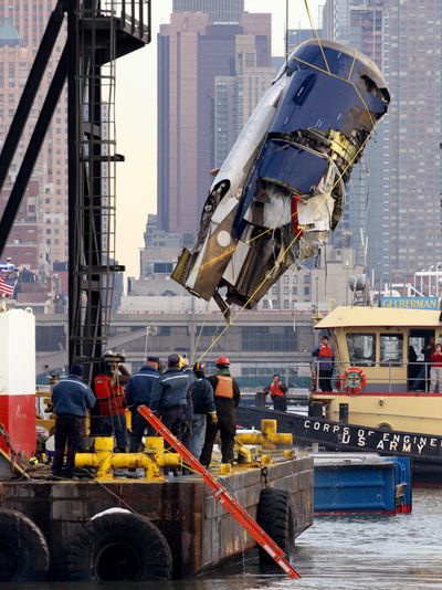 The left engine of US Airways Flight 1549  – which crash-landed into the water on Jan. 15 – can be seen as it is retrieved from the icy Hudson River in New York on Friday.  (Associated Press / The Spokesman-Review)