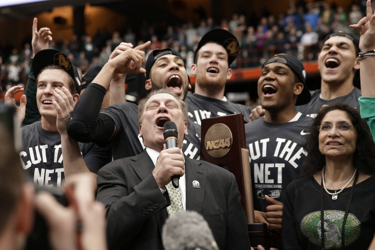 Michigan State coach Tom Izzo celebrates with his team after the Spartans defeated Louisville in the East Regional final. (Associated Press)