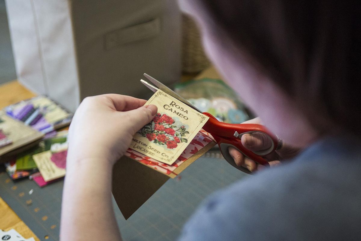 Julie Collette-Thompson works on one of her cards that she sells at local community fairs on Friday, July 13, 2018, in Everett. (Olivia Vanni / For The Spokesman-Review)