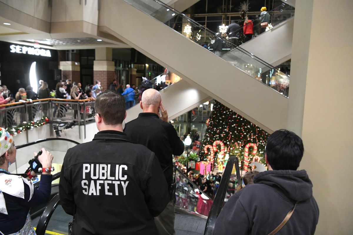 Police arrested a man after he fought a public safety officer at River Park Square on Saturday. In this 2018 photo, members of mall security monitor the progress of Santa Claus as he rides down the escalator to the ground floor. (Jesse Tinsley / The Spokesman-Review)